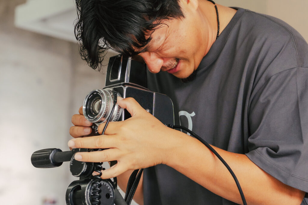 ファインダーを覗く村上佑